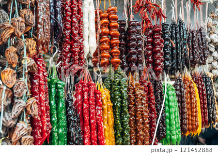 Churchkhela made from nuts hangs at a local market. 121452888