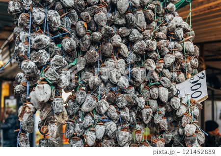 Dried persimmon fruits are sold at the market 121452889