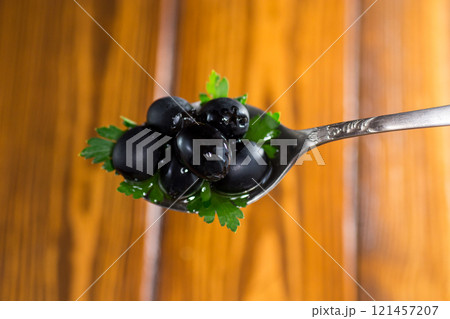 black olives in a spoon black olives in a spoon 121457207