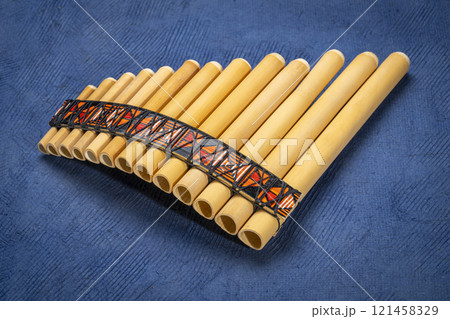 bamboo pan flute instrument from Peru against textured art paper 121458329