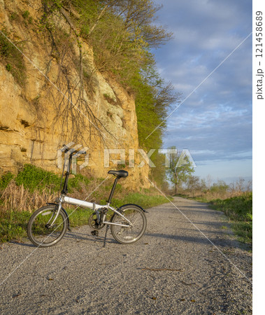 folding bike on Steamboat Trace, bike trail converted from an abandoned railroad, near Peru, Nebraska, springtime morning scenery folding bike on Steamboat Trace, bike trail converted from an abandoned railroad, near Peru, Nebraska, springtime morning scenery 121458689