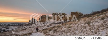 winter sunrise over a trail at Colorado foothills with a distant runner - Devils Backbone rock formation near Loveland winter sunrise over a trail at Colorado foothills with a distant runner - Devils Backbone rock formation near Loveland 121458699