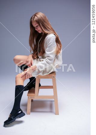 An Impressive and Stylish Portrait Featuring a Model on a Stool Set in a Minimalist Environment 121459056