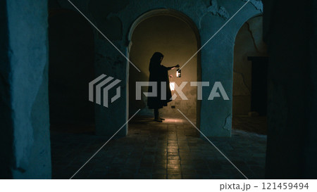 Silhouette Of The Monk Moving Inside The Columns Of The Church  121459494
