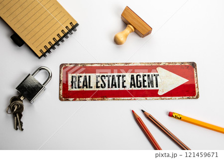 Real Estate Agent. Red metal sign on a white office desk 121459671