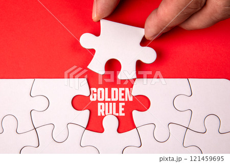 Golden Rule. White puzzle pieces on an red background Golden Rule. White puzzle pieces on an red background 121459695