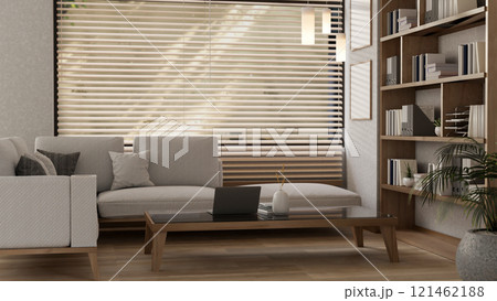 A cozy, contemporary minimalist living room features a large sofa and a laptop on a coffee table. 121462188