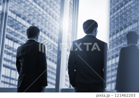 two asian businesspeople talking chatting standing by the window talking chatting in office 121462203