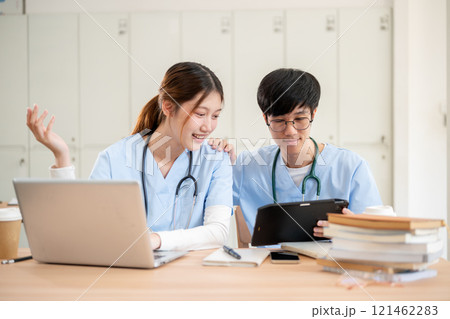 Smart Asian female and male medical students are working together on medical research homework. Smart Asian female and male medical students are working together on medical research homework. 121462283