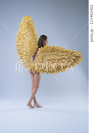 Woman With Golden Angel Wings posing naked with bodyart Woman With Golden Angel Wings posing naked with bodyart 121462402