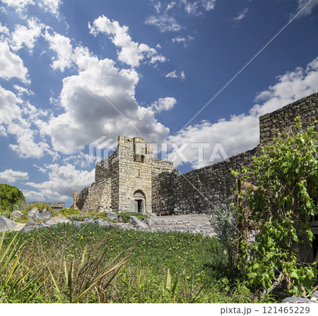 Ruins of Azraq Castle (Qasr al-Azraq) is a crusader castle (300AD),  central-eastern Jordan, 100 km east of Amman, Jordan. Against the background of a beautiful sky with clouds 121465229