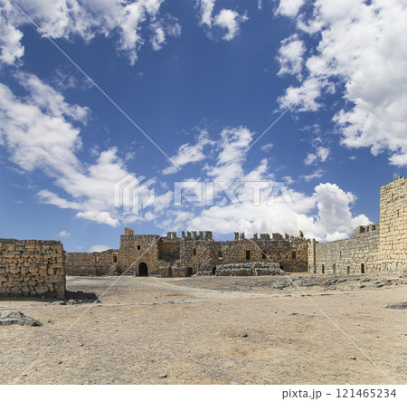 Ruins of Azraq Castle (Qasr al-Azraq) is a crusader castle (300AD), central-eastern Jordan, 100 km east of Amman, Jordan. Against the background of a beautiful sky with clouds Ruins of Azraq Castle (Qasr al-Azraq) is a crusader castle (300AD), central-eastern Jordan, 100 km east of Amman, Jordan. Against the background of a beautiful sky with clouds 121465234