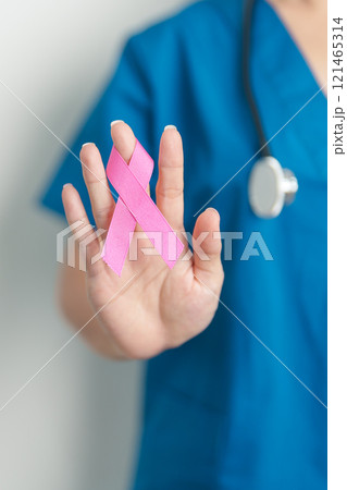 Pink October Breast Cancer Awareness month, woman doctor with pink Ribbon in hospital for support people life and illness. National cancer survivors month, Mother and World cancer day concept Pink October Breast Cancer Awareness month, woman doctor with pink Ribbon in hospital for support people life and illness. National cancer survivors month, Mother and World cancer day concept 121465314