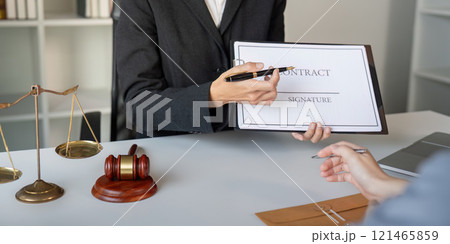 Asian lawyer explaining contract details to client 121465859