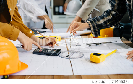 Creative architect projecting on the big drawings with architectural project Creative architect projecting on the big drawings with architectural project 121466872