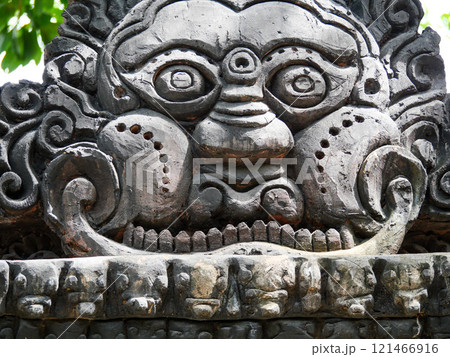 Stone carving of a face with a mouth and a nose Stone carving of a face with a mouth and a nose 121466916