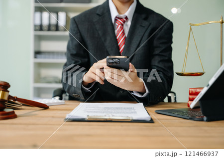 justice and law concept. Male judge in a courtroom the gavel, working with smart phone and laptop and digital tablet justice and law concept. Male judge in a courtroom the gavel, working with smart phone and laptop and digital tablet 121466937