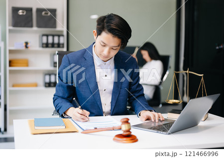 Asian man lawyer working and gavel, tablet, laptop in front, Advice justice and law concept. 121466996