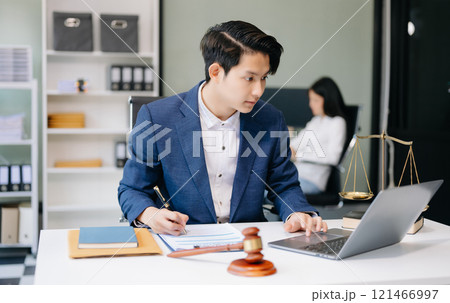 Asian man lawyer working and gavel, tablet, laptop in front, Advice justice and law concept. 121466997