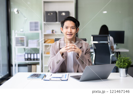 Young attractive Asian male office worker business suits smiling at camera 121467146