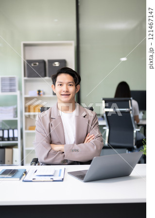 Young attractive Asian male office worker business suits smiling at camera 121467147