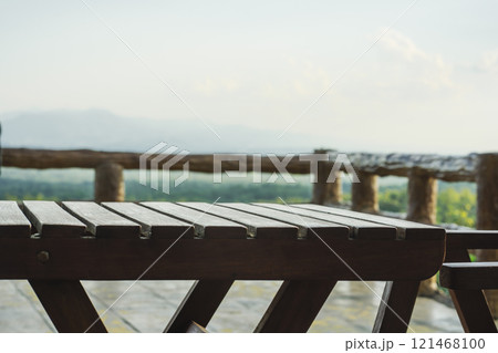 travel and people activity concept with wood chair in restaurant with mountain and tropical forest background 121468100