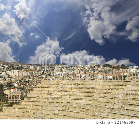 Amphitheater in Jerash (Gerasa of Antiquity), capital and largest city of Jerash Governorate, Jordan. Against the background of a beautiful sky with clouds Amphitheater in Jerash (Gerasa of Antiquity), capital and largest city of Jerash Governorate, Jordan. Against the background of a beautiful sky with clouds 121468697