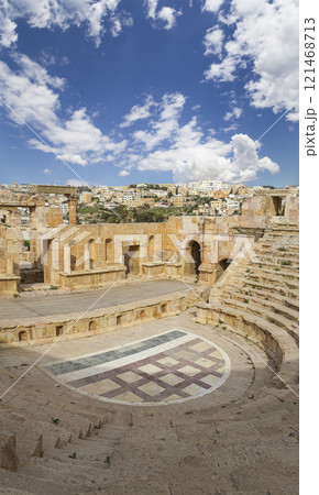 Amphitheater in Jerash (Gerasa of Antiquity), capital and largest city of Jerash Governorate, Jordan. Against the background of a beautiful sky with clouds 121468713