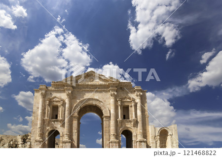 Arch of Hadrian in Gerasa (Jerash)-- was built to honor the visit of emperor Hadrian to Jerash in 129/130 AD, Jordan. Against the background of a beautiful sky with clouds Arch of Hadrian in Gerasa (Jerash)-- was built to honor the visit of emperor Hadrian to Jerash in 129/130 AD, Jordan. Against the background of a beautiful sky with clouds 121468822