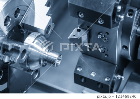 The CNC lathe machine forming  cutting the metal shaft parts in the light blue scene. 121469240