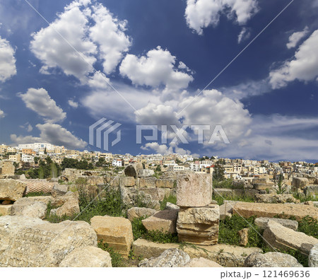 Roman ruins (against the background of a beautiful sky with clouds) in the Jordanian city of Jerash (Gerasa of Antiquity), capital and largest city of Jerash Governorate, Jordan Roman ruins (against the background of a beautiful sky with clouds) in the Jordanian city of Jerash (Gerasa of Antiquity), capital and largest city of Jerash Governorate, Jordan 121469636