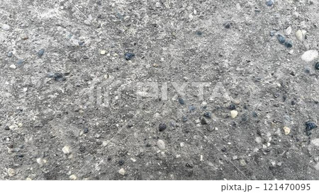 Textured surface of concrete with pebbles and small stones in daylight 121470095