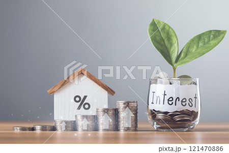 Stacks of coins arranged in ascending order with a small house model placed on a table, Home loan interest, mortgage refinancing, saving for housing, Planning for homeownership and stability 121470886