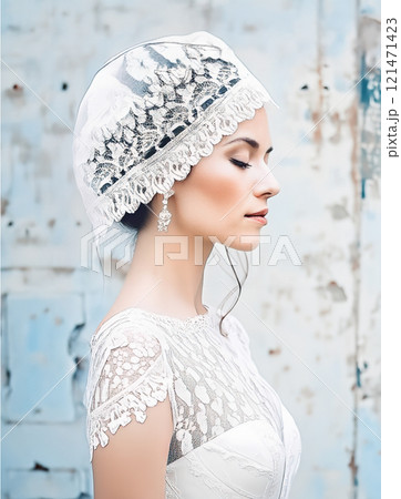 The image features a woman dressed in a vintage-style bridal look,complete with a white lacy corset and a decorative headpiece,set against a gritty, urban background 121471423