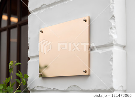 Blank gold glass signboard on gray textured wall mockup. 121473066