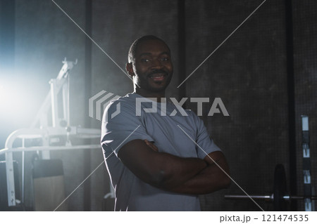 Fitness workout in gym. Portrait of African American man standing in gym with motivation health energy ready for training. Athletic coach personal trainer fitness club owner. Healthy lifestyle 121474535