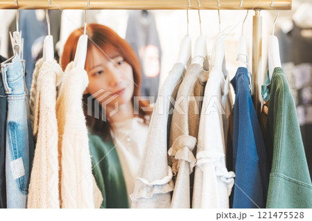 ショッピングで服を選ぶ女性【撮影協力・沼垂テラス商店街】 ショッピングで服を選ぶ女性【撮影協力・沼垂テラス商店街】 121475528