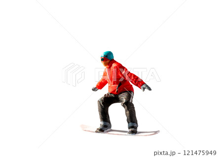 Miniature figurine depicting a snowboarder in mid-motion isolate on white background with clipping path 121475949