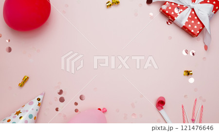 Concept of festive birthday celebrations. Birthday attributes colorful balloons, party hats, candles, confetti 121476646