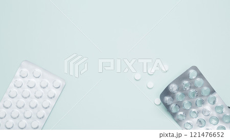 Blister of tablets with pills on a light blue background. Concept of medicine, healthcare, and pharmaceutical industry Blister of tablets with pills on a light blue background. Concept of medicine, healthcare, and pharmaceutical industry 121476652