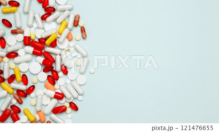 Concept of medicine, healthcare, and pharmaceutical industry. Various colorful pills and capsules scattered Concept of medicine, healthcare, and pharmaceutical industry. Various colorful pills and capsules scattered 121476655