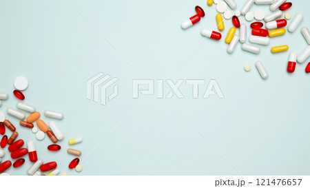 Concept of medicine, healthcare, pharmaceutical industry. Various colorful pills and capsules scattered Concept of medicine, healthcare, pharmaceutical industry. Various colorful pills and capsules scattered 121476657