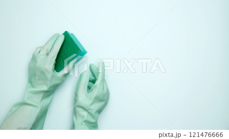 House cleaning. Woman hand in rubber glove holds dishwashing sponge House cleaning. Woman hand in rubber glove holds dishwashing sponge 121476666