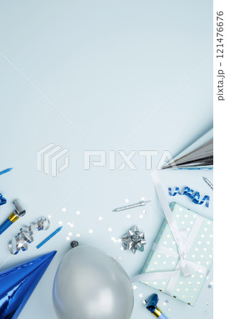 Concept of festive birthday celebrations. Birthday attributes colorful balloons, party hats, candles, confetti Concept of festive birthday celebrations. Birthday attributes colorful balloons, party hats, candles, confetti 121476676