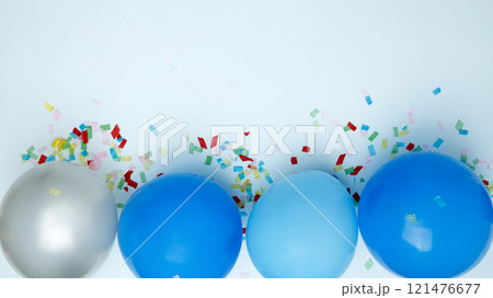 Concept of festive birthday celebrations. Birthday attributes colorful balloons confetti Concept of festive birthday celebrations. Birthday attributes colorful balloons confetti 121476677