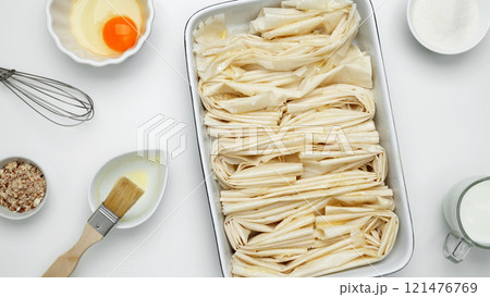 Crinkle Cake butter for buttering, filo dough in a baking dish near 121476769