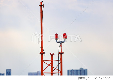 Obstruction light, an aircraft warning light on top of a highrise of building. 121478682