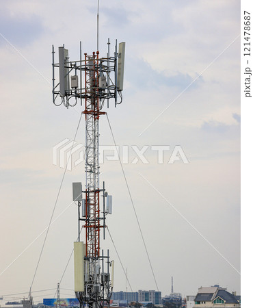 Wireless Communication Antenna pole, Mobile phone mast antenna pole on top of dilapidated building 121478687