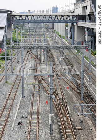 Aerial view of Infrastructure of railway tracks equipped with overhead electric poles in parallel to high powered supply lines in suburban. Aerial view of Infrastructure of railway tracks equipped with overhead electric poles in parallel to high powered supply lines in suburban. 121478690