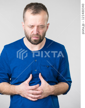 Man feeling stomach ache pain 121480340